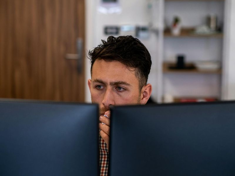 Close up of a professional focusing on a task in a bright office