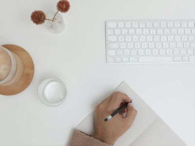 Organized desk with a notebook and a glass of water